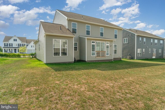 rear view of property with a yard