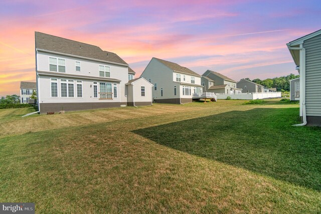 back of house with a yard