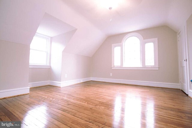 bonus room with lofted ceiling and light hardwood / wood-style flooring