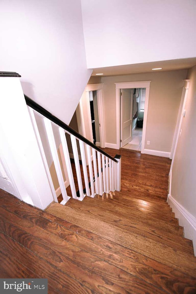 stairs featuring hardwood / wood-style floors