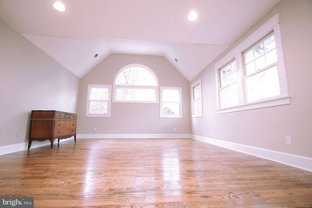 interior space with hardwood / wood-style flooring and vaulted ceiling