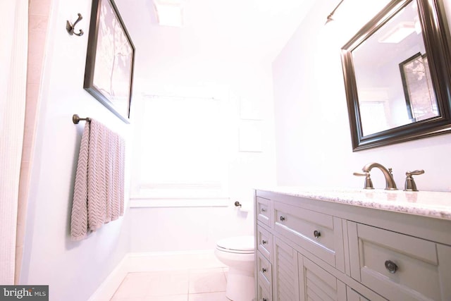 bathroom featuring vanity, tile patterned flooring, and toilet