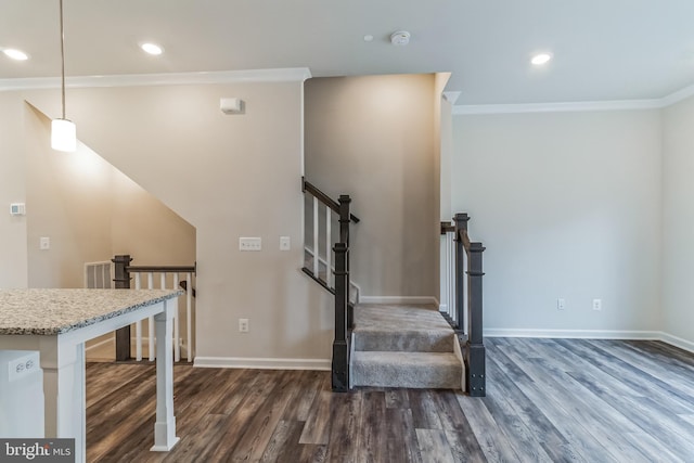 stairs featuring ornamental molding and wood-type flooring