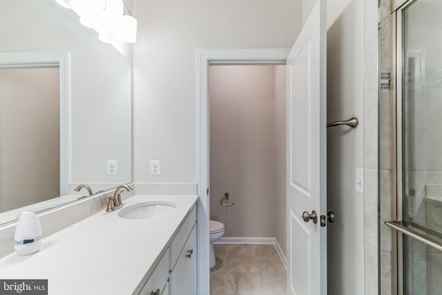 bathroom featuring an enclosed shower, vanity, tile patterned floors, and toilet