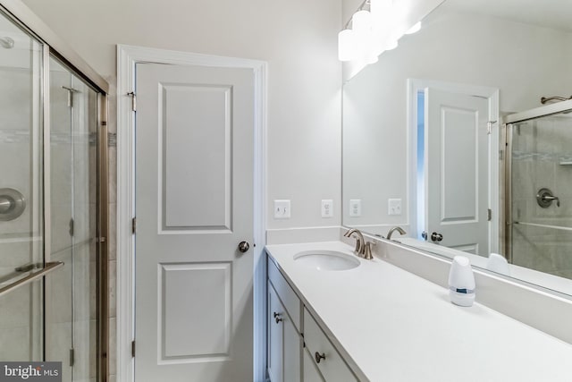 bathroom featuring vanity and an enclosed shower