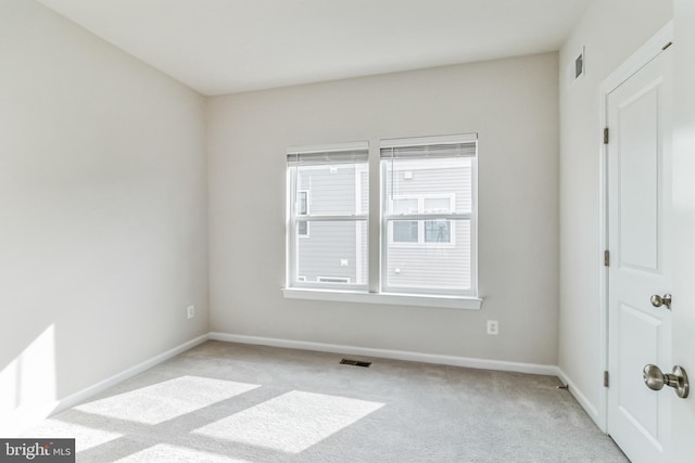 unfurnished room with light colored carpet