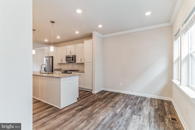 kitchen featuring light stone counters, pendant lighting, stainless steel appliances, and white cabinets