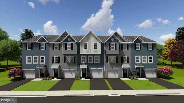 view of front of home with a garage and a front lawn