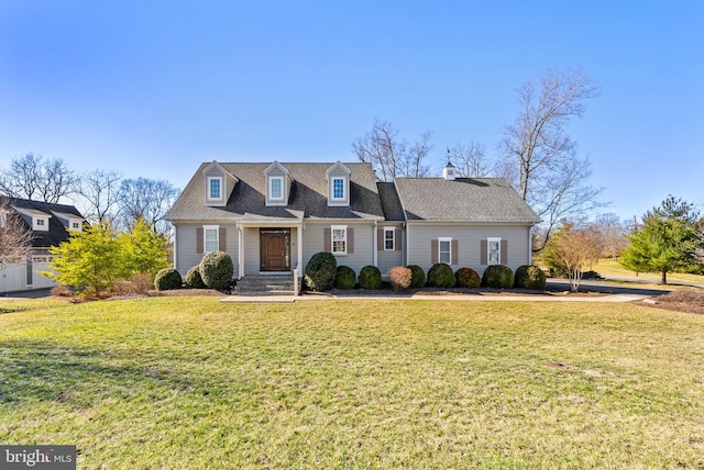 cape cod-style house with a front yard