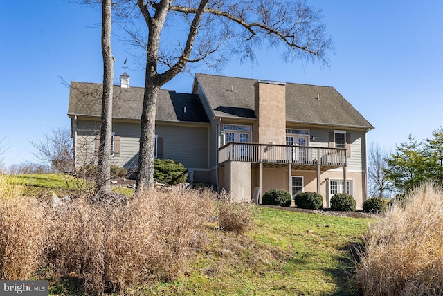 rear view of property with a lawn