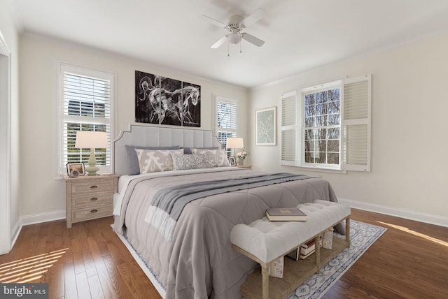 bedroom with crown molding, dark hardwood / wood-style floors, and ceiling fan