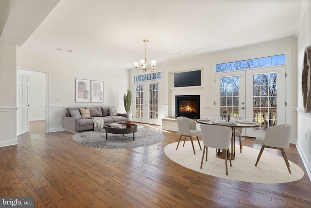 living room with french doors, hardwood / wood-style flooring, and a chandelier