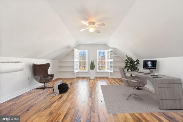 office area featuring light hardwood / wood-style flooring, lofted ceiling, and ceiling fan