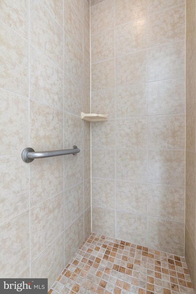 bathroom with tiled shower