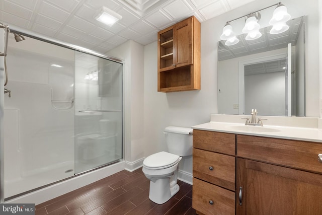 bathroom featuring a shower with door, toilet, hardwood / wood-style flooring, and vanity