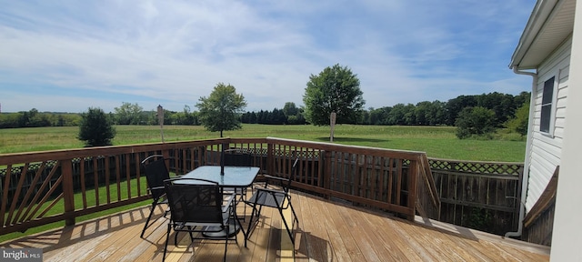 wooden deck with a yard and a rural view