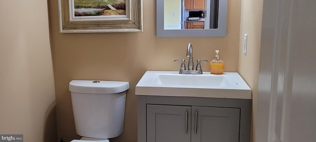 bathroom featuring toilet and vanity