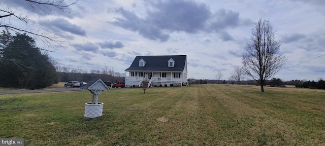 view of front facade featuring covered porch and a front yard