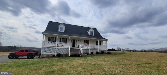 cape cod house featuring a front lawn and covered porch