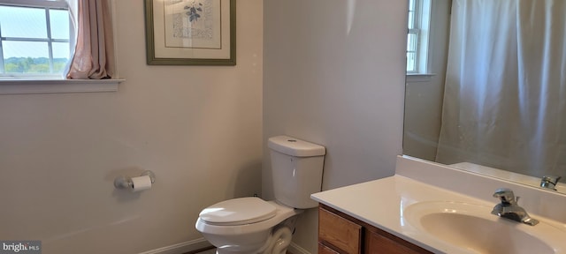 bathroom featuring toilet and vanity