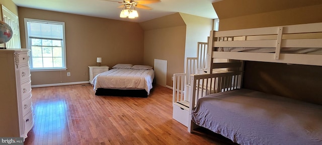 bedroom featuring lofted ceiling, light hardwood / wood-style flooring, and ceiling fan