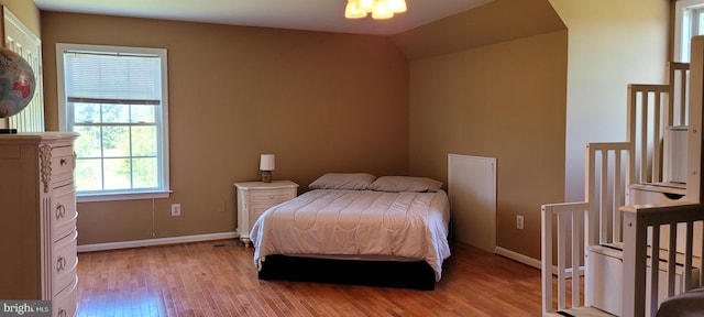 bedroom featuring vaulted ceiling and hardwood / wood-style flooring