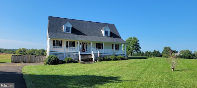 cape cod house with a porch and a front lawn