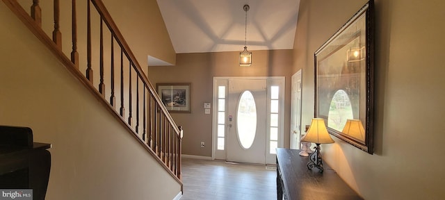 entryway featuring vaulted ceiling and light hardwood / wood-style flooring