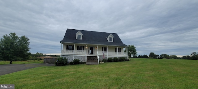 cape cod home featuring a porch and a front lawn