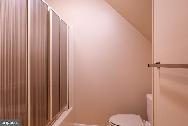 bathroom with lofted ceiling and toilet