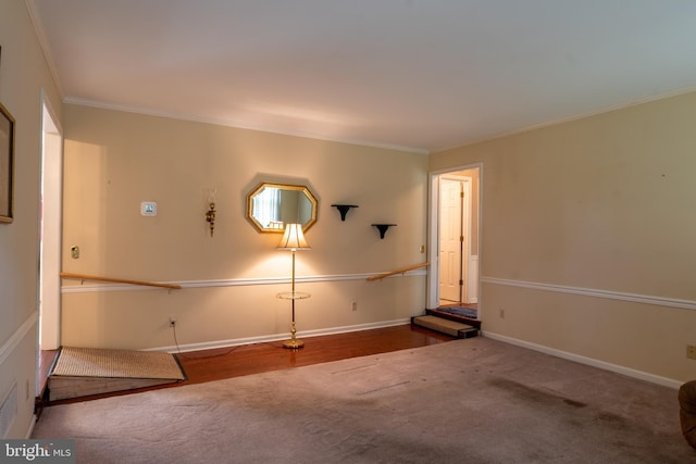 carpeted empty room featuring ornamental molding and baseboards