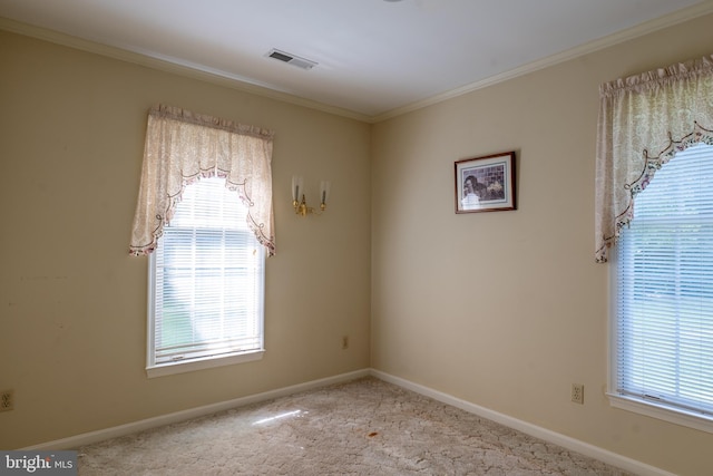 unfurnished room with baseboards, crown molding, visible vents, and carpet flooring