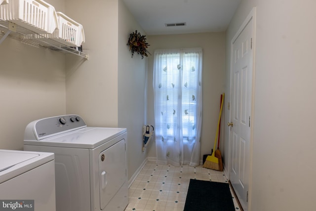 laundry room with washing machine and dryer, laundry area, visible vents, baseboards, and light floors