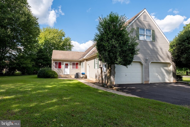 view of front of property featuring aphalt driveway, an attached garage, central AC unit, entry steps, and a front lawn