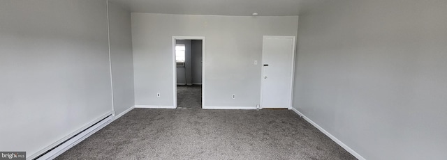 carpeted empty room featuring a baseboard radiator