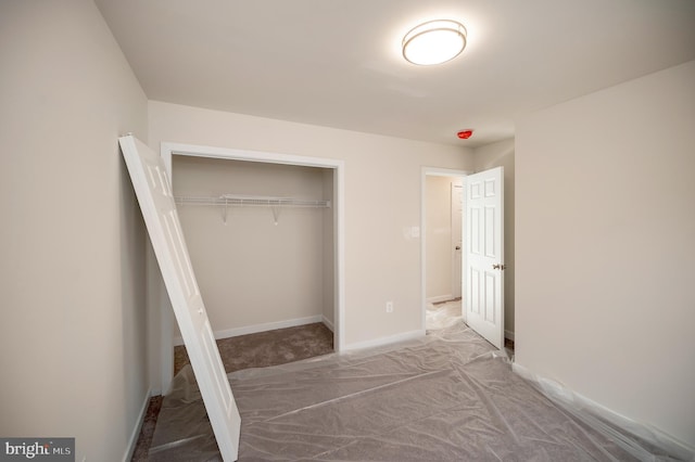 unfurnished bedroom featuring a closet and carpet