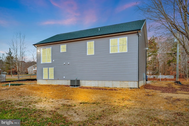 property exterior at dusk with central AC unit