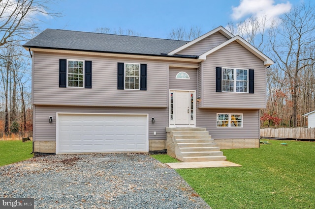 split foyer home with a garage and a front yard