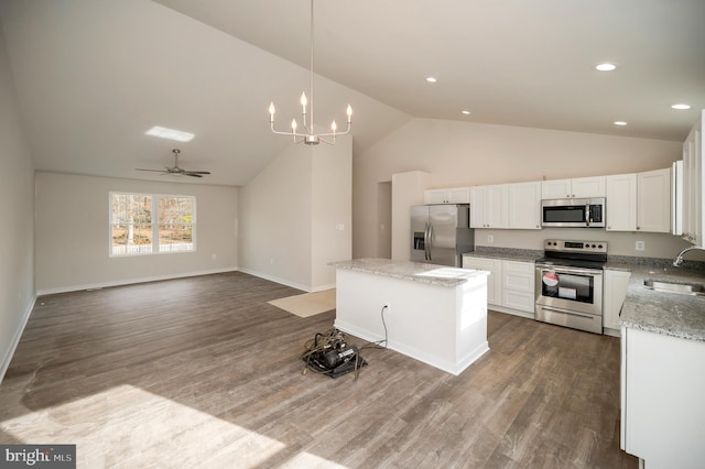 kitchen with a kitchen island, decorative light fixtures, white cabinetry, sink, and stainless steel appliances