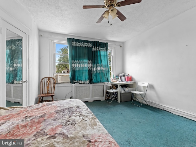 bedroom featuring multiple windows, ceiling fan, carpet, and a textured ceiling