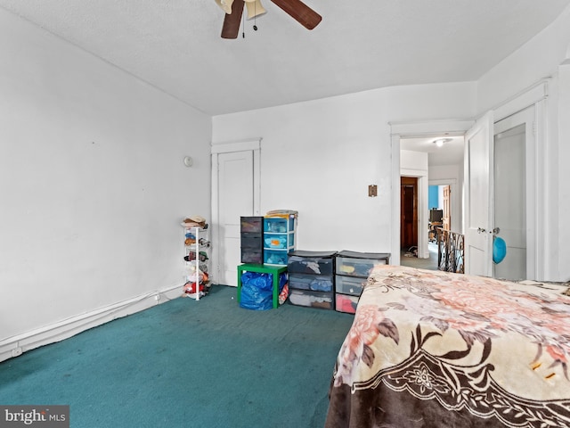 carpeted bedroom with ceiling fan and a textured ceiling