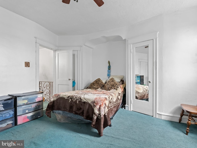 bedroom featuring ceiling fan, carpet floors, and a textured ceiling