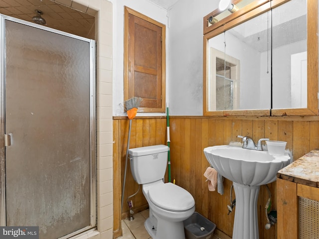 bathroom with walk in shower, wooden walls, tile patterned flooring, and toilet