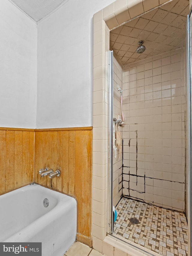 bathroom with plus walk in shower and wood walls