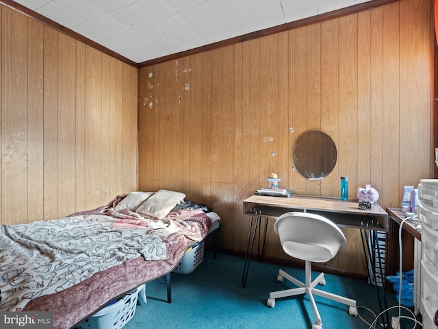 carpeted bedroom with ornamental molding and wood walls