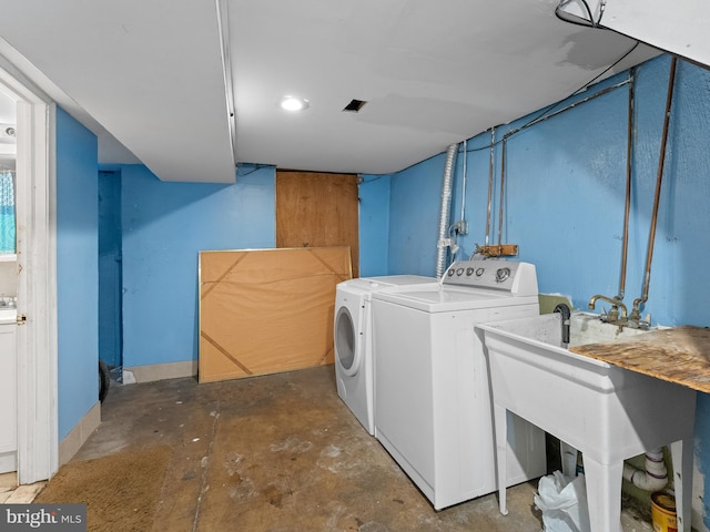 washroom featuring separate washer and dryer and sink