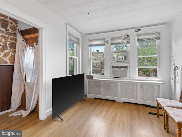 interior space featuring radiator heating unit and cooling unit