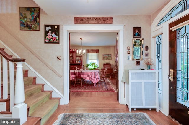 entrance foyer with a chandelier and hardwood / wood-style floors