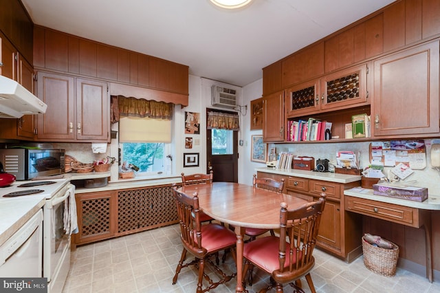 kitchen featuring white appliances and an AC wall unit