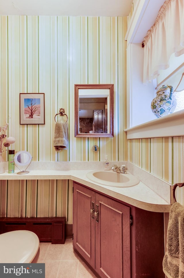 bathroom with vanity, tile patterned floors, and toilet